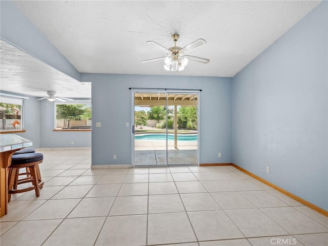 7556 Glider Ave, Hesperia, CA 92345 - empty room featuring ceiling fan, healthy amount of natural light, a textured ceiling, and light tile patterned flooring