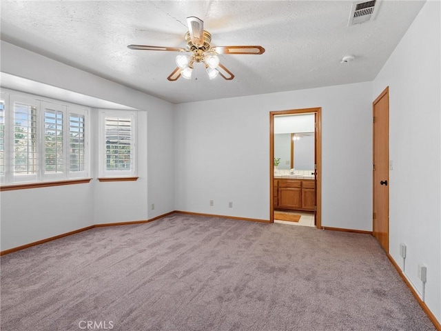 7556 Glider Ave, Hesperia, CA 92345 - unfurnished bedroom with light carpet, a textured ceiling, ensuite bath, and ceiling fan