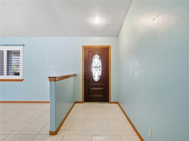 7556 Glider Ave, Hesperia, CA 92345 - entryway featuring a textured ceiling, light tile patterned flooring, and lofted ceiling