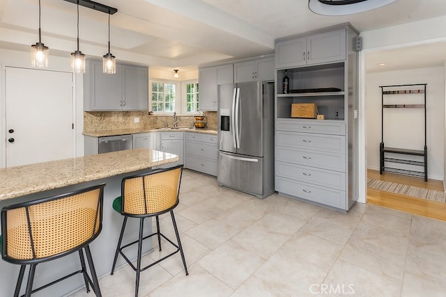 8398 Shoup Ave, West Hills, CA 91304 - kitchen featuring stainless steel appliances, gray cabinetry, tasteful backsplash, light stone countertops, and pendant lighting