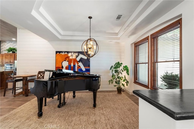 54774 Bautista Rd, Anza, CA 92539 - sitting room with light wood-style floors, a raised ceiling, a chandelier, and wood walls