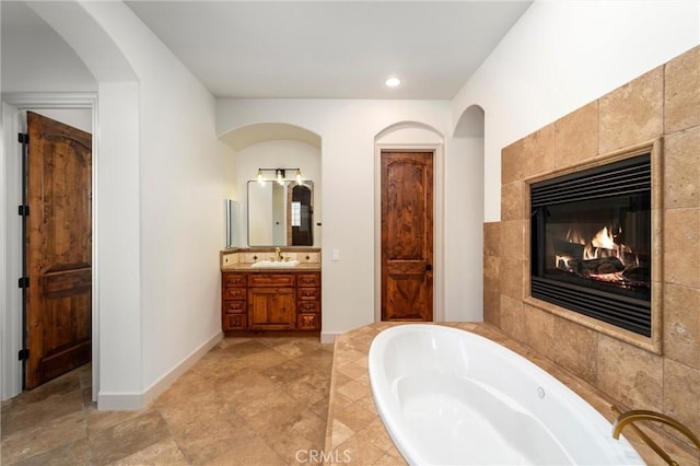 54774 Bautista Rd, Anza, CA 92539 - full bath with vanity, a garden tub, a tile fireplace, and recessed lighting