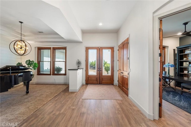 54774 Bautista Rd, Anza, CA 92539 - entryway featuring wood finished floors, a chandelier, and a raised ceiling