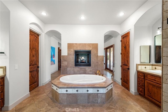 54774 Bautista Rd, Anza, CA 92539 - bathroom with vanity, a garden tub, a fireplace, and recessed lighting