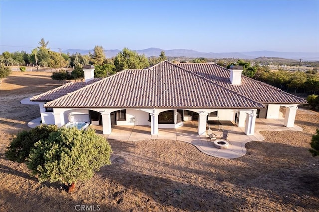 54774 Bautista Rd, Anza, CA 92539 - back of property featuring a chimney, a tiled roof, a patio area, and stucco siding