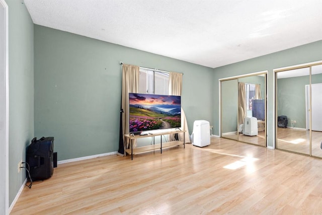 475 N Midway Dr Unit 230, Escondido, CA 92027 - bedroom featuring multiple closets and wood finished floors