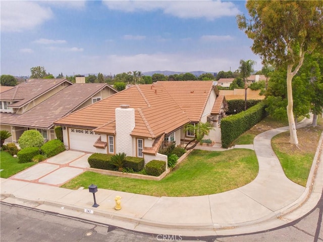 747 De Jesus, Placentia, CA 92870 - view of front of home with a tile roof, an attached garage, concrete driveway, and a front yard