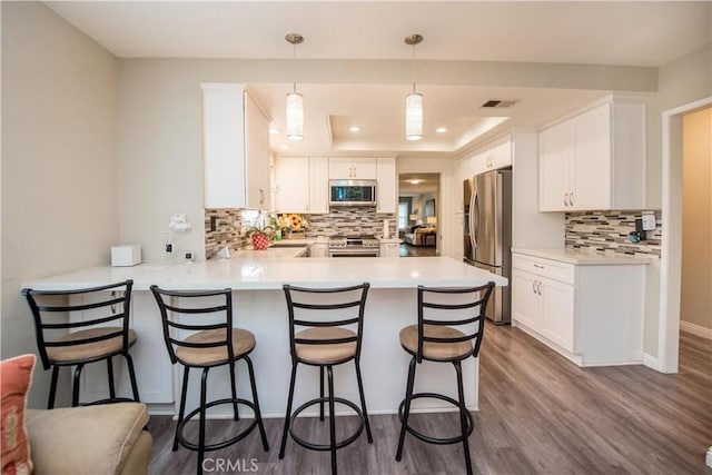 747 De Jesus, Placentia, CA 92870 - kitchen with appliances with stainless steel finishes, a peninsula, tasteful backsplash, white cabinetry, and light countertops