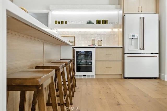 3756 Goodland Ave, Studio City, CA 91604 - indoor dry bar with white refrigerator with ice dispenser, wine cooler, light wood-style floors, and backsplash