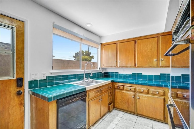 10422 Gilbert St, Anaheim, CA 92804 - kitchen with dishwasher, light tile patterned floors, plenty of natural light, and brown cabinets
