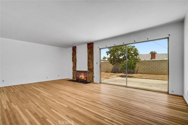 10422 Gilbert St, Anaheim, CA 92804 - unfurnished living room with a stone fireplace and wood finished floors