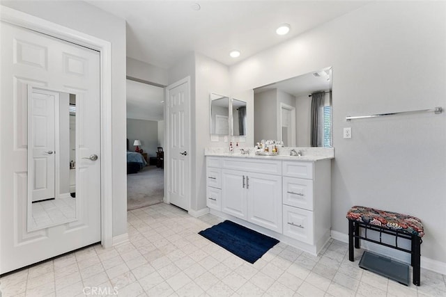 4073 Tamarind Rdg, Lake Elsinore, CA 92530 - bathroom featuring double vanity, ensuite bath, and recessed lighting