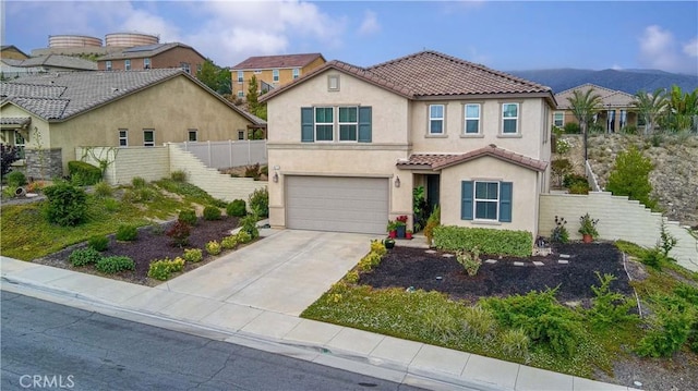 4073 Tamarind Rdg, Lake Elsinore, CA 92530 - mediterranean / spanish-style home featuring a tile roof, stucco siding, a garage, and concrete driveway