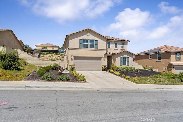 4073 Tamarind Rdg, Lake Elsinore, CA 92530 - view of front facade featuring a garage, concrete driveway, stucco siding, and a tile roof