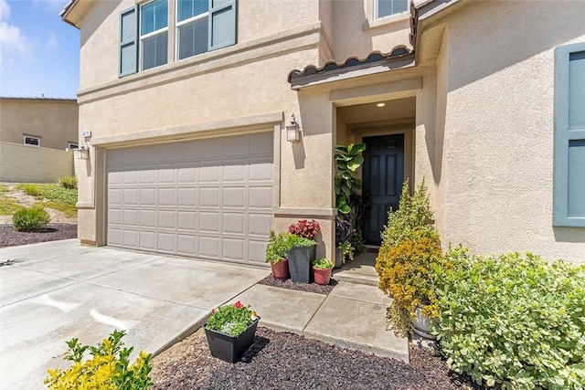 4073 Tamarind Rdg, Lake Elsinore, CA 92530 - property entrance featuring stucco siding, an attached garage, and concrete driveway