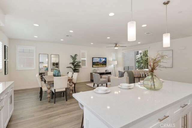 542 Cultivate, Irvine, CA 92618 - kitchen with light wood-style flooring, light countertops, white cabinetry, and recessed lighting