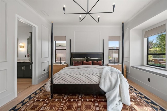 1115 Myles Ln, Nipomo, CA 93444 - bedroom featuring light wood-style flooring, a chandelier, ornamental molding, and connected bathroom