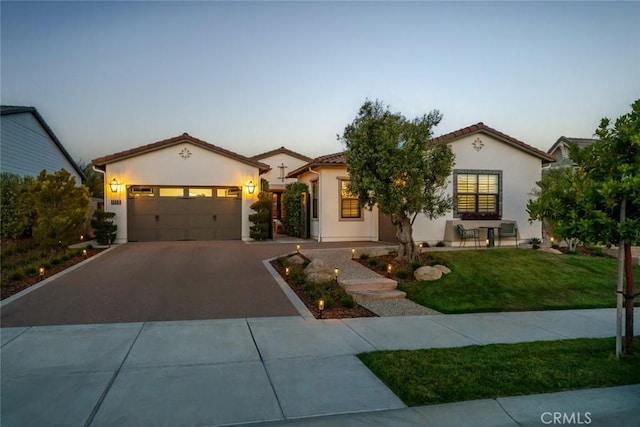 1115 Myles Ln, Nipomo, CA 93444 - mediterranean / spanish-style home with asphalt driveway, stucco siding, an attached garage, a front yard, and a tile roof