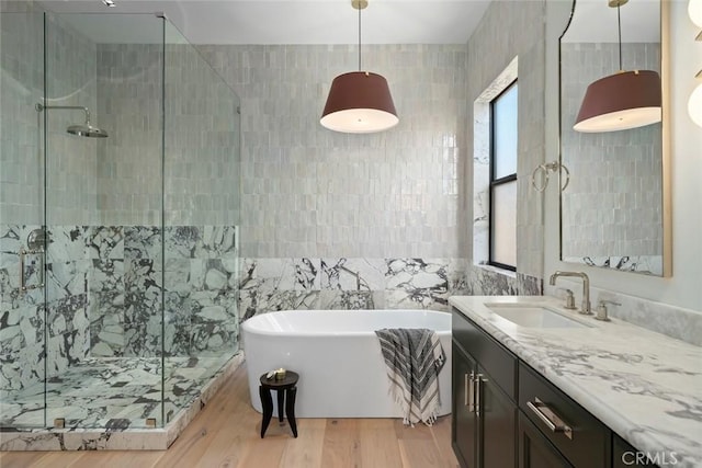 1115 Myles Ln, Nipomo, CA 93444 - full bath with tile walls, a soaking tub, a shower stall, vanity, and wood finished floors