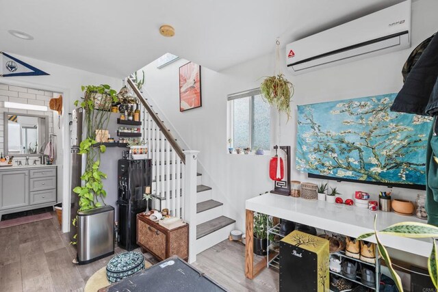 1009 S Cleveland St, Oceanside, CA 92054 - staircase featuring an AC wall unit and wood finished floors
