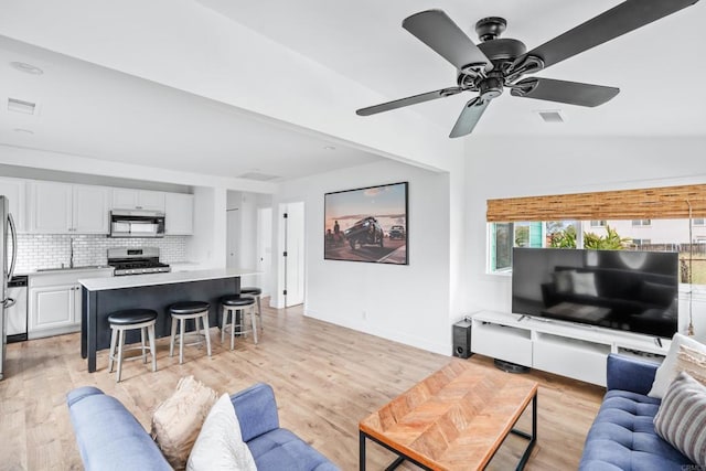 1009 S Cleveland St, Oceanside, CA 92054 - living room with a ceiling fan, light wood finished floors, and lofted ceiling