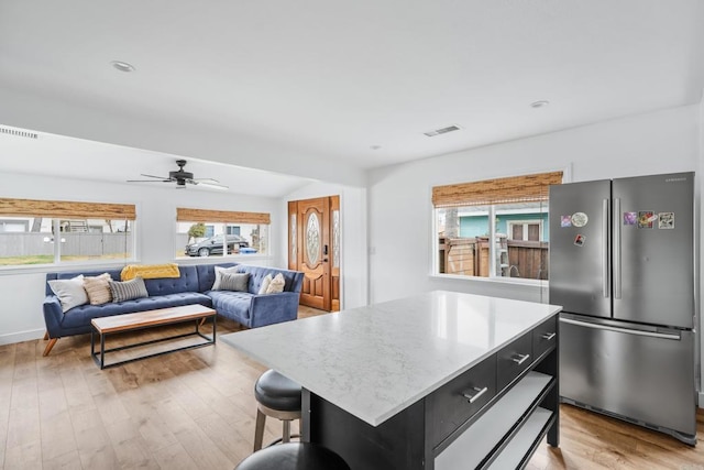 1009 S Cleveland St, Oceanside, CA 92054 - kitchen featuring freestanding refrigerator, dark cabinets, light wood finished floors, open floor plan, and a center island