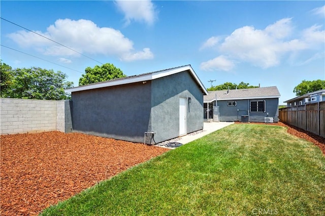 149 N Vail Ave, Montebello, CA 90640 - back of property featuring a fenced backyard, stucco siding, and an outbuilding