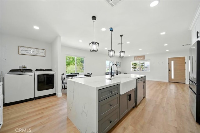 149 N Vail Ave, Montebello, CA 90640 - kitchen with washing machine and dryer, gray cabinetry, appliances with stainless steel finishes, recessed lighting, and light wood-type flooring