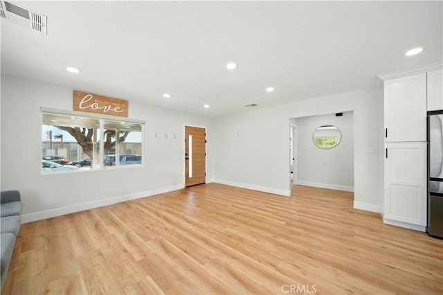 149 N Vail Ave, Montebello, CA 90640 - unfurnished living room with recessed lighting and light wood-style floors