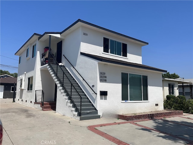 3029 Pacific Ave, Long Beach, CA 90806 - view of front of house featuring stucco siding and stairway