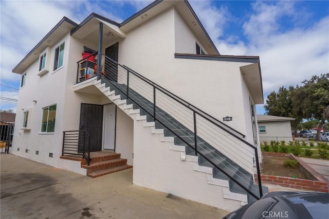 3029 Pacific Ave, Long Beach, CA 90806 - view of side of home with stairway, stucco siding, and crawl space
