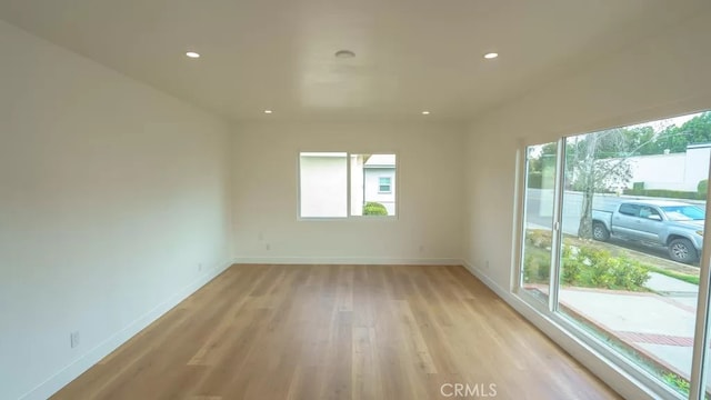 3029 Pacific Ave, Long Beach, CA 90806 - empty room with healthy amount of natural light, light wood-type flooring, and recessed lighting