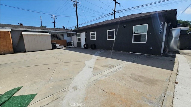 3029 Pacific Ave, Long Beach, CA 90806 - back of property featuring a patio, a storage shed, and stucco siding