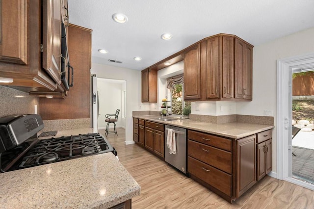 3430 Corte Viejo, Carlsbad, CA 92009 - kitchen with stainless steel appliances, plenty of natural light, recessed lighting, and dark brown cabinets