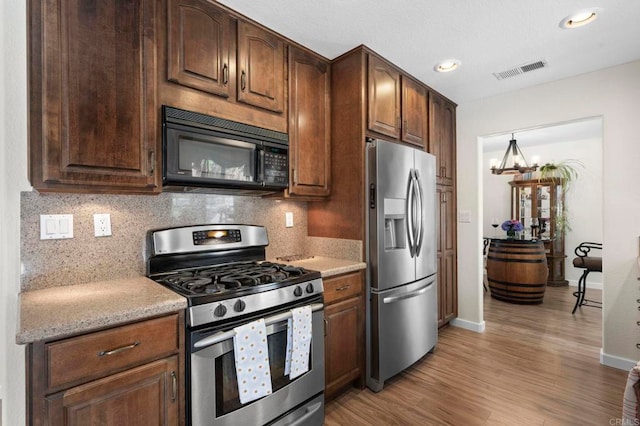 3430 Corte Viejo, Carlsbad, CA 92009 - kitchen featuring stainless steel appliances, backsplash, light wood-style flooring, dark brown cabinets, and recessed lighting