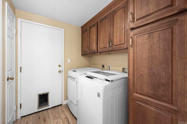 3430 Corte Viejo, Carlsbad, CA 92009 - washroom with cabinet space, washing machine and clothes dryer, and light wood finished floors