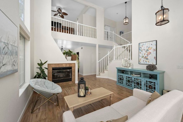 3430 Corte Viejo, Carlsbad, CA 92009 - living area featuring a towering ceiling, stairway, wood finished floors, ceiling fan, and a fireplace