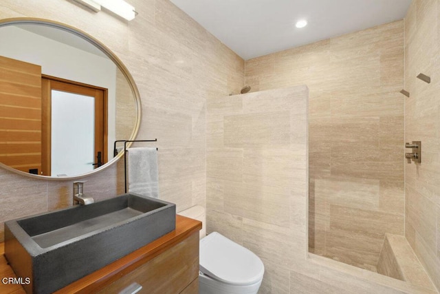 572 Skyline Rd, Ventura, CA 93003 - bathroom featuring tile walls, vanity, tiled shower, and decorative backsplash