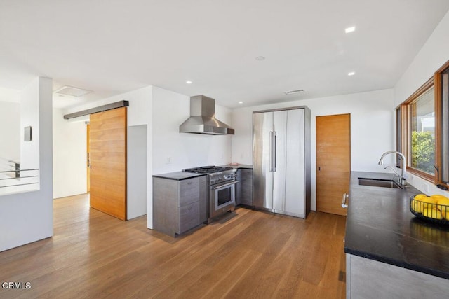572 Skyline Rd, Ventura, CA 93003 - kitchen with wall chimney range hood, stainless steel range, wood finished floors, recessed lighting, and modern cabinets