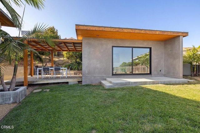 572 Skyline Rd, Ventura, CA 93003 - back of house with a wooden deck, a lawn, outdoor dining area, and stucco siding