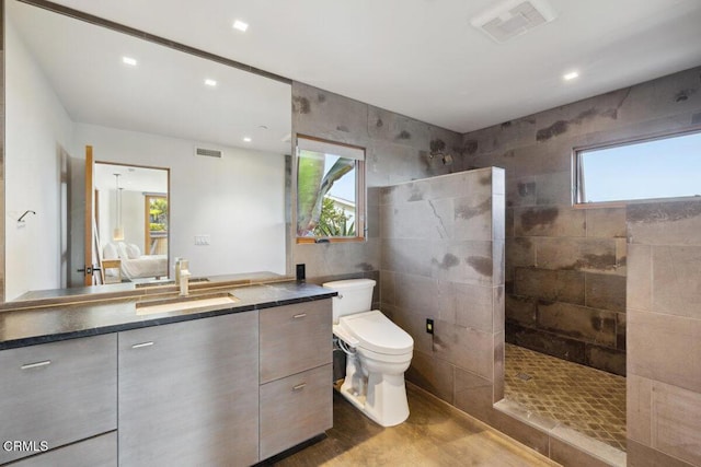 572 Skyline Rd, Ventura, CA 93003 - bathroom with vanity, a walk in shower, tile walls, wood finished floors, and recessed lighting