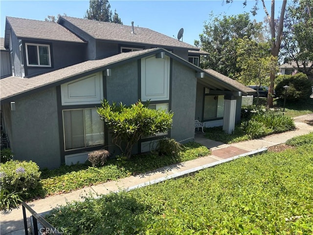 20359 Ivy Hill Ln Unit 13, Yorba Linda, CA 92886 - view of side of property featuring stucco siding and a shingled roof