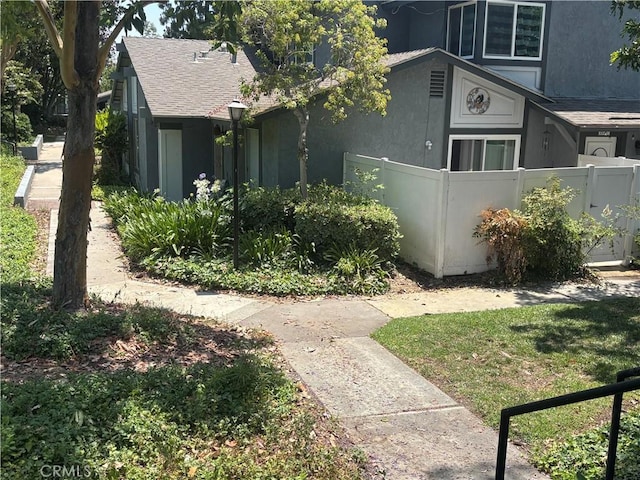 20359 Ivy Hill Ln Unit 13, Yorba Linda, CA 92886 - view of property exterior featuring stucco siding and a shingled roof