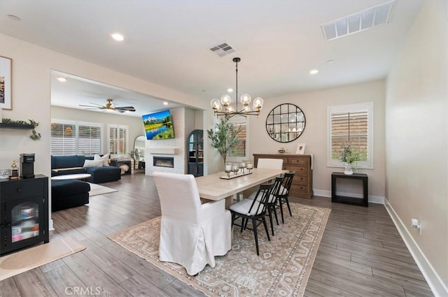 2516 Chad Zeller Ln, Corona, CA 92882 - dining area with recessed lighting, wood finished floors, a fireplace, a chandelier, and ceiling fan