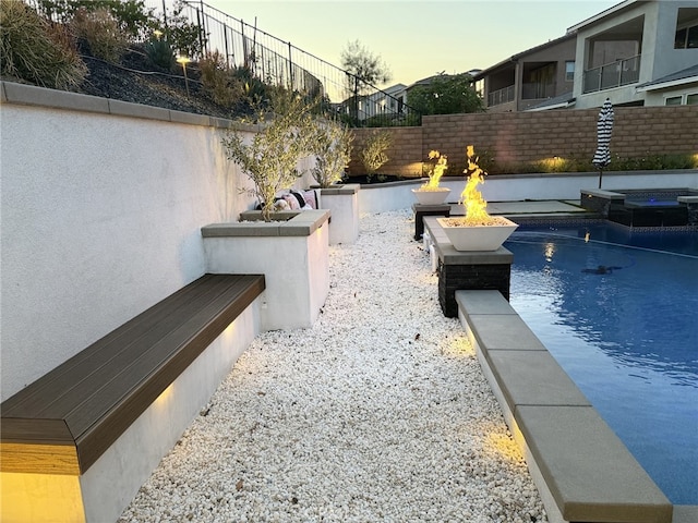2516 Chad Zeller Ln, Corona, CA 92882 - pool at dusk featuring an outdoor fire pit and a pool with connected hot tub