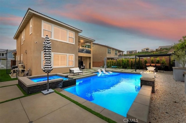 2516 Chad Zeller Ln, Corona, CA 92882 - pool at dusk with a fire pit, a patio area, and a pool with connected hot tub