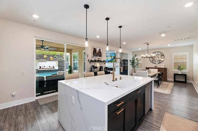 2516 Chad Zeller Ln, Corona, CA 92882 - kitchen with open floor plan, a ceiling fan, an island with sink, a chandelier, and recessed lighting