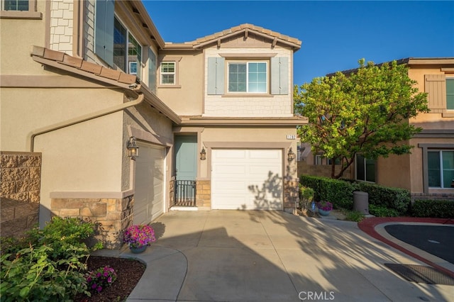 1782 Saige View Cir, Upland, CA 91784 - view of property with an attached garage, stucco siding, driveway, and stone siding