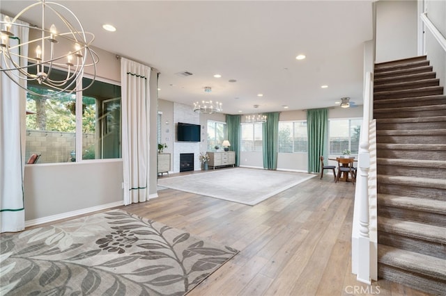 1782 Saige View Cir, Upland, CA 91784 - unfurnished living room featuring a chandelier, light wood-style floors, recessed lighting, a fireplace, and stairs