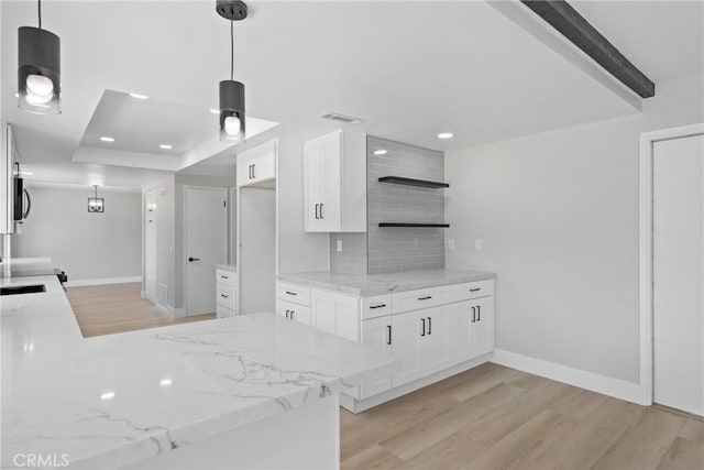 18684 Santa Ynez St, Fountain Valley, CA 92708 - kitchen with light wood-style floors, backsplash, open shelves, light stone countertops, and white cabinets